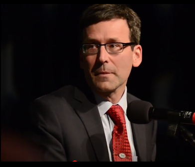 Bob Ferguson speaks at the Spokane County Democrat Party's Tom Foley Dinner in 2017, while his office was "investigating" them before filing a "lawsuit"