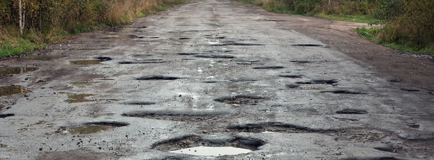 Picture of a road filled with potholes.

From: https://www.wethegoverned.com/wp-content/uploads/2017/05/rogh-road-potholes.jpg